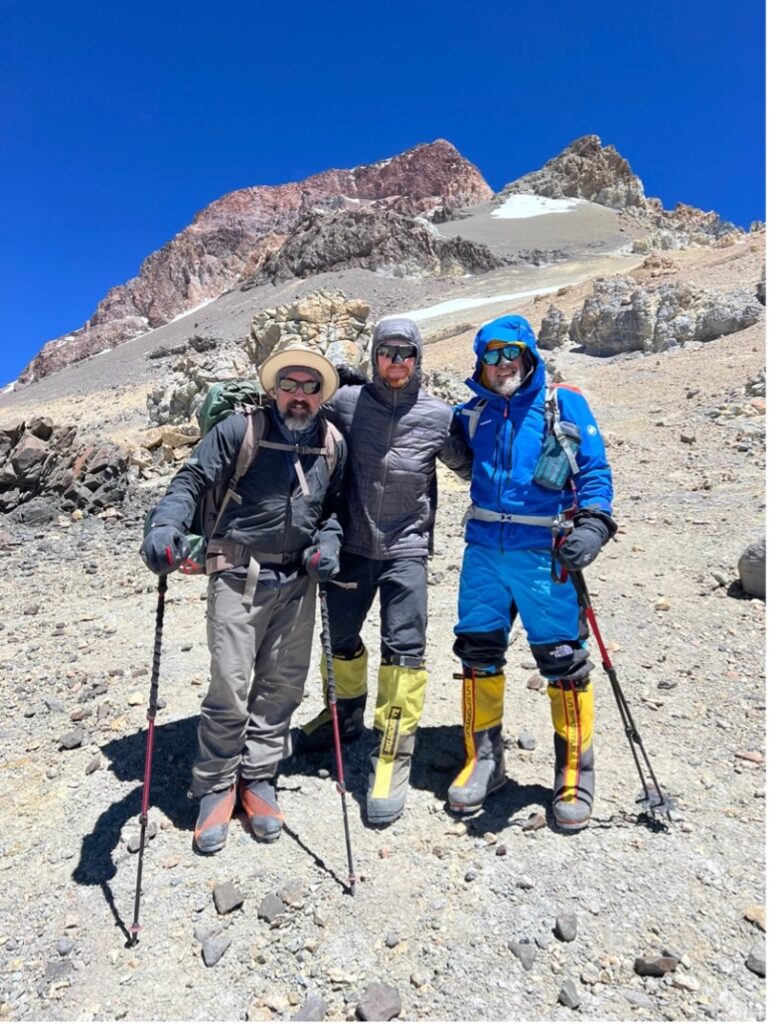 President Glenn and his brothers dressed in cold weather climbing gear near the summit of Mount Aconcagua