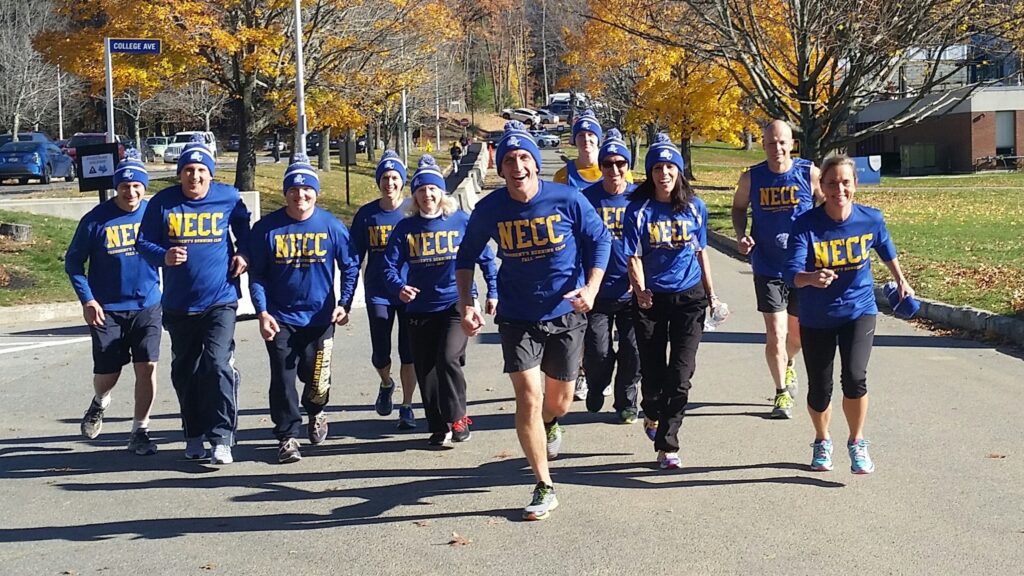 A group of people wearing matching blue shirts and hats

Description automatically generated