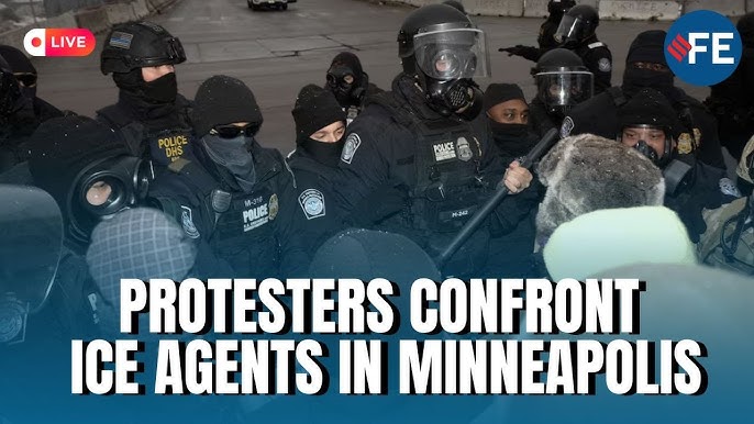 Armed, masked ICE agents confront sign carrying protesters in the street