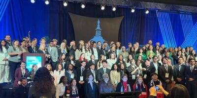 Two-hundred community college students on stage at a conference